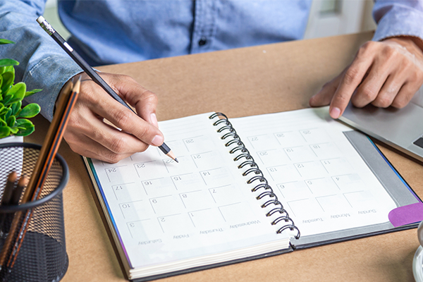 Man writing on calendar