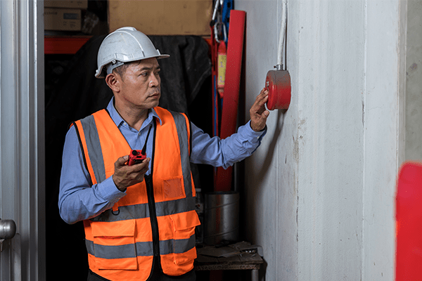 Man inspecting fire alarms