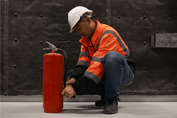 Man inspecting fire extinguisher